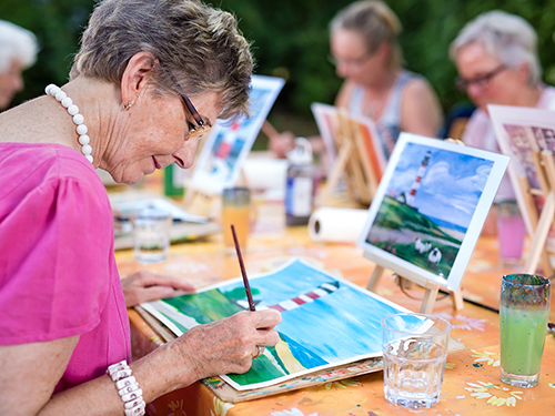 Group of women taking a painting class together>